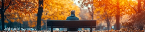 Man Sitting Alone on a Bench in the Autumn Park. Generative AI photo