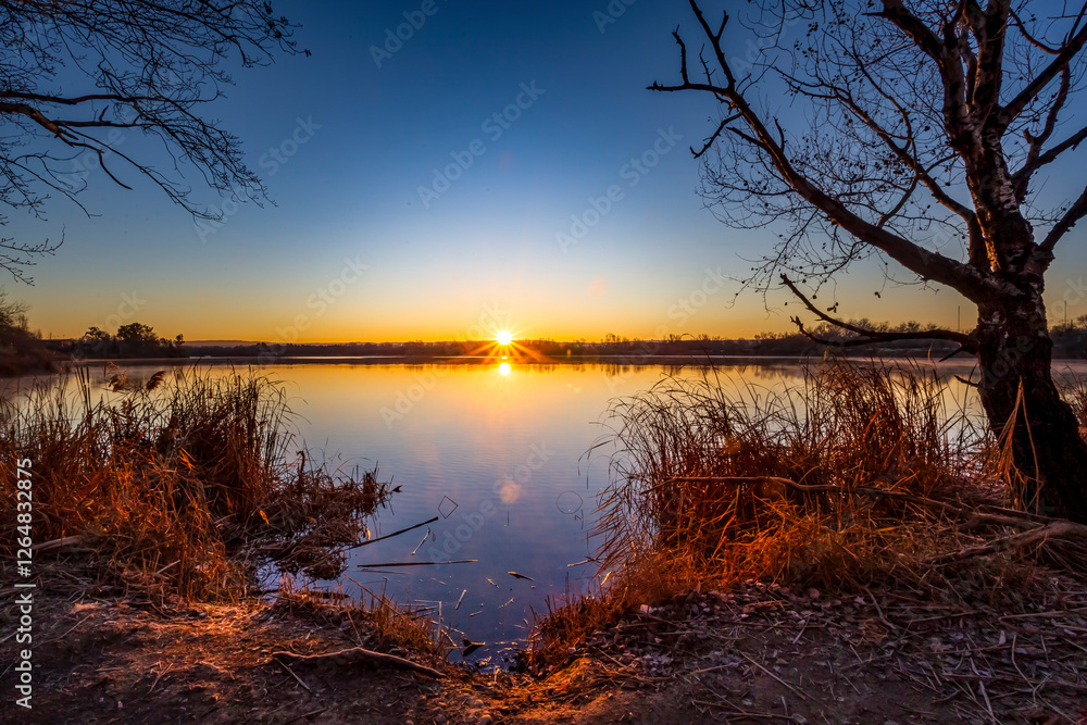 The sun rising reflected on The Campillo lagoon. The sun rising reflected on The Campillo lagoon.