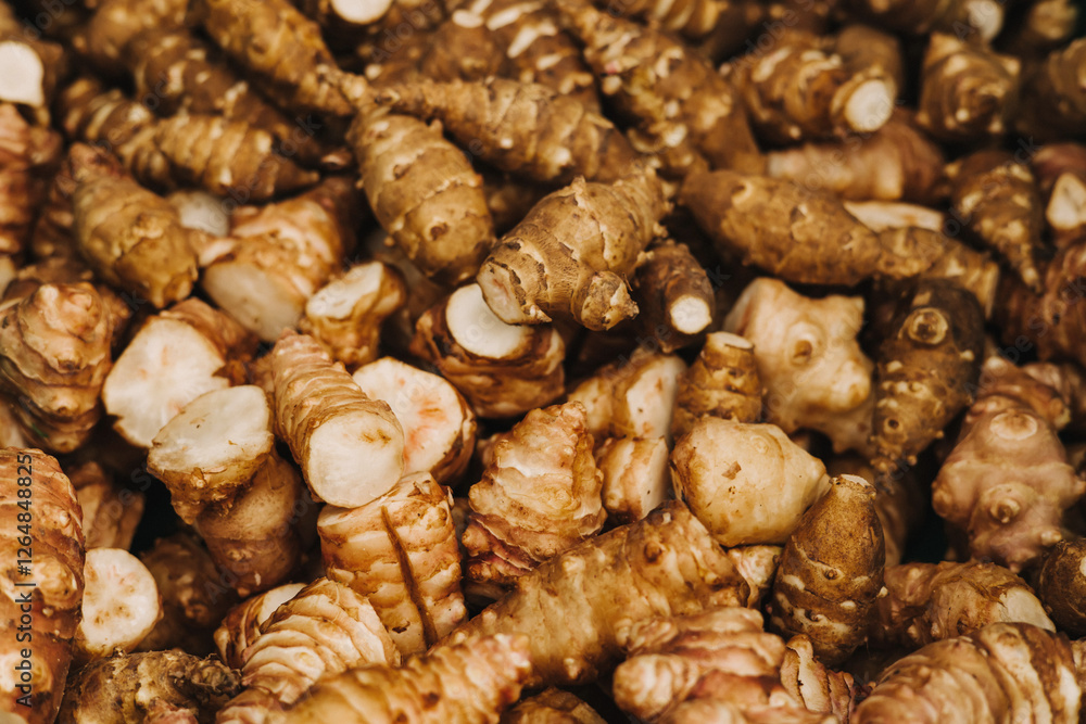 Group of fresh jerusalem artichokes background. Jerusalem artichokes or sunroot or sunchoke. Vegetarian food. Close-up, top view Group of fresh jerusalem artichokes background. Jerusalem artichokes or sunroot or sunchoke. Vegetarian food. Close-up, top view