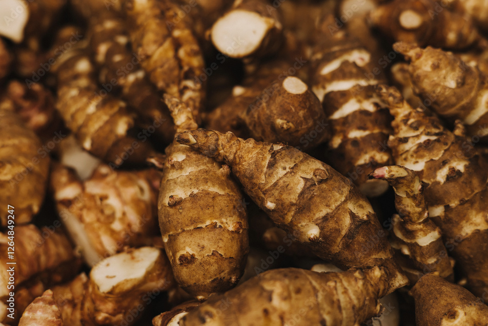Group of fresh jerusalem artichokes background. Jerusalem artichokes or sunroot or sunchoke. Vegetarian food. Close-up, top view Group of fresh jerusalem artichokes background. Jerusalem artichokes or sunroot or sunchoke. Vegetarian food. Close-up, top view