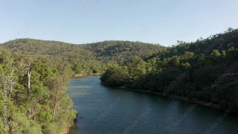Drone push shot flying low along a river in a steep-sided Australian bushland valley Drone push shot flying low along a river in a steep-sided Australian bushland valley