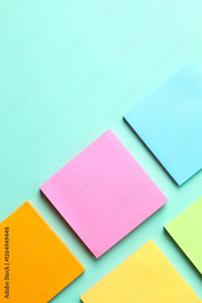Top view of stacks of colorful sticky notes on color background Top view of stacks of colorful sticky notes on color background