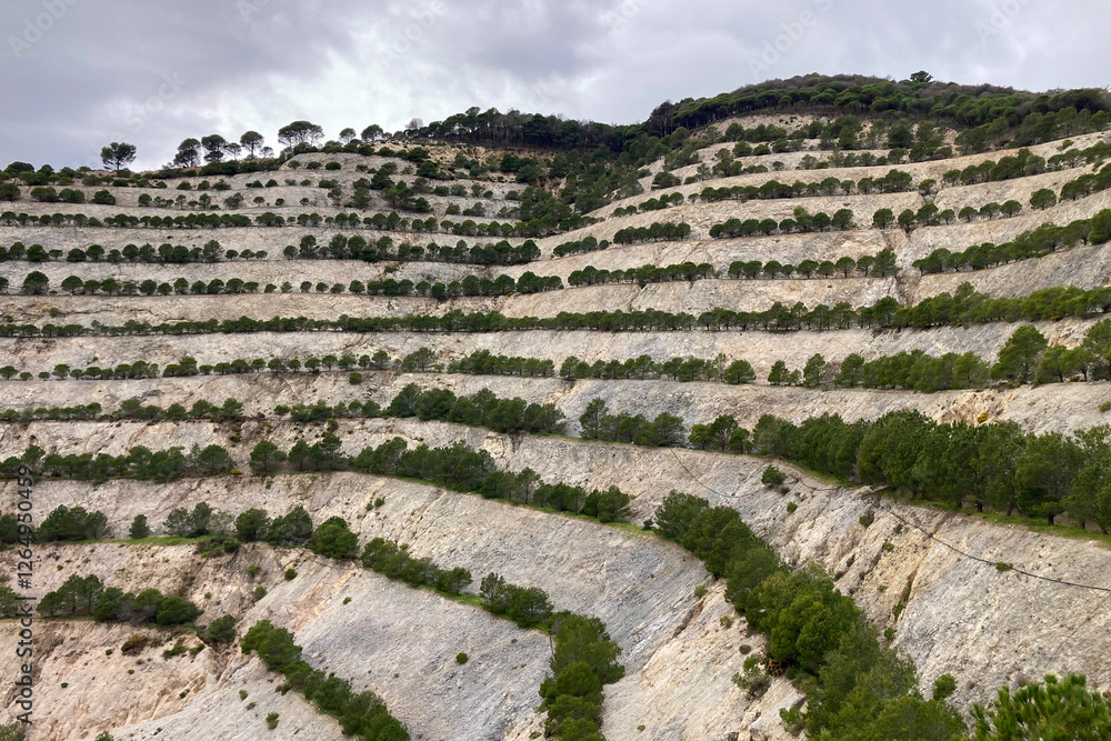 Hiking on trail along abandoned open-pit mine and burnt trees near Mijas, Spain Hiking on trail along abandoned open-pit mine and burnt trees near Mijas, Spain
