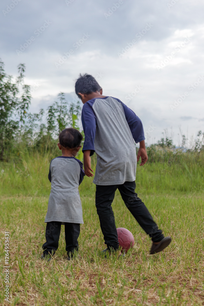 Brotherly Bond Playing Soccer in a Rural Field Brotherly Bond Playing Soccer in a Rural Field
