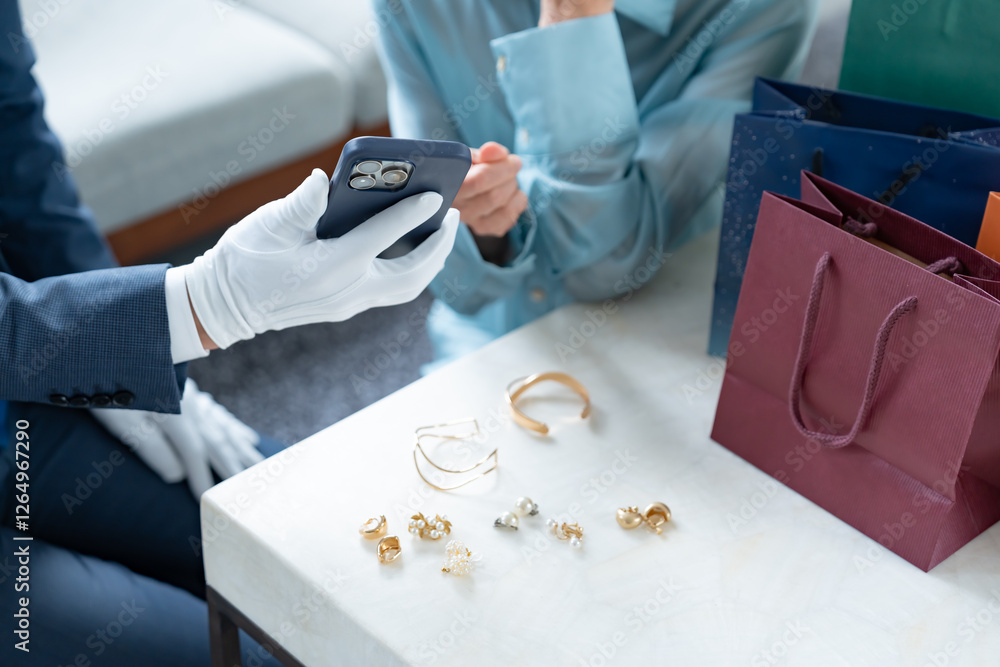 Obraz premium 携帯の画面を見せる手袋をつけた男性