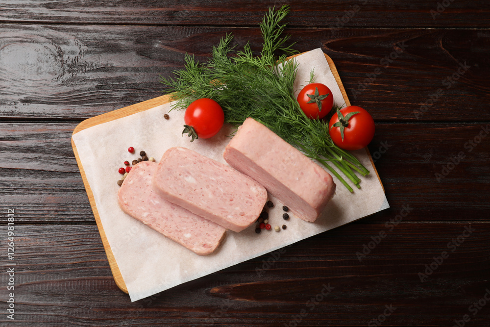 Pieces of tasty canned meat, tomatoes, dill and peppercorns on wooden table, top view Pieces of tasty canned meat, tomatoes, dill and peppercorns on wooden table, top view