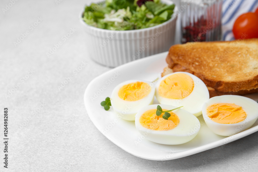 Hard boiled eggs with bread on light table, closeup. Space for text Hard boiled eggs with bread on light table, closeup. Space for text
