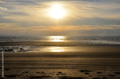 Seascape. Sandy seashore at sunset at low tide