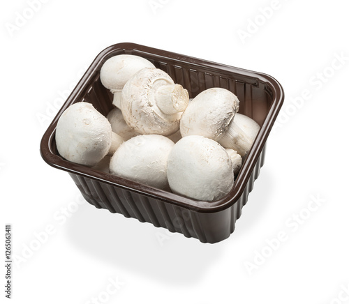 Fresh champignon mushrooms. Fresh champignons in plastic box isolated on white background.  photo