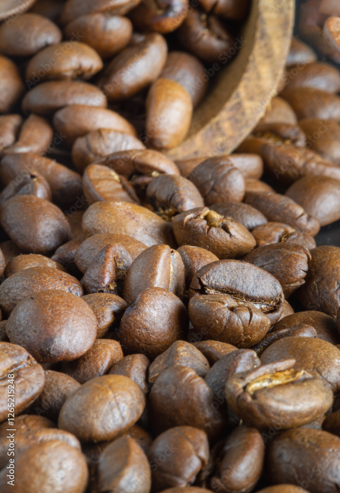 Close-up view of Roasted coffee beans on a rich textured surface. Enjoy your morning coffee for living, use it as your Space for text, Design, Wallpaper and Poster, Selective focus.