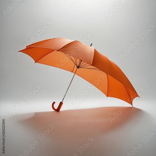 A minimalist bright orange umbrella opened against a seamless white backdrop.