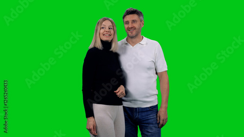 Beautiful laughing mid adult loving couple on green chroma key background