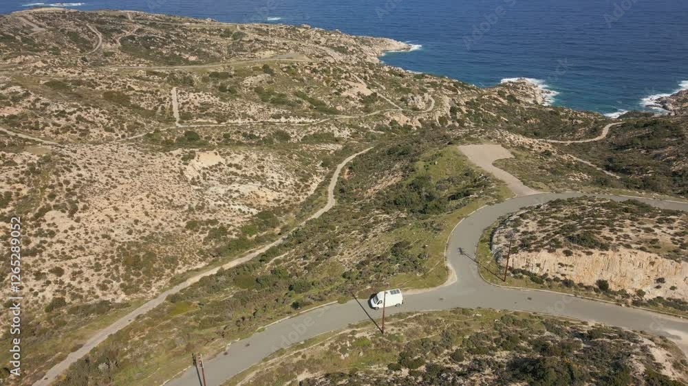 Camper van with solar panels on the roof driving on Kriaritsi project area drone aerial top view with abandoned roads in the south of Greece Camper van with solar panels on the roof driving on Kriaritsi project area drone aerial top view with abandoned roads in the south of Greece