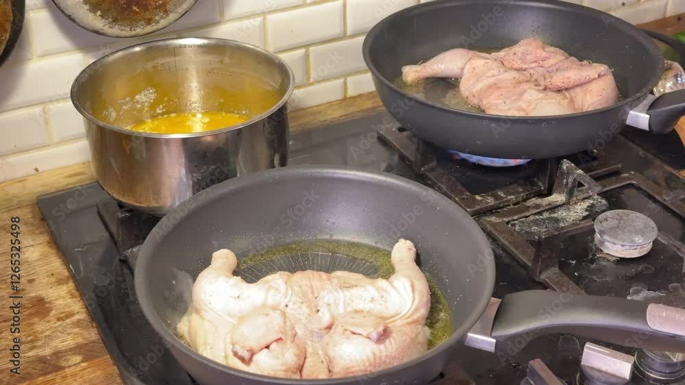 a man pan-frying tobacco chicken a man pan-frying tobacco chicken