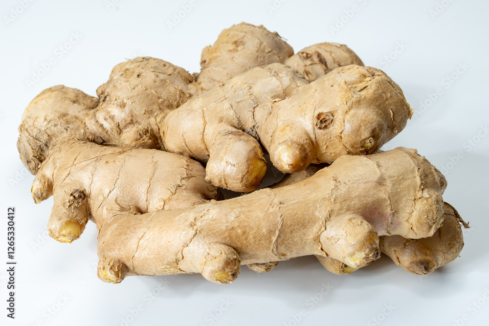 Fresh organic ginger rhizome root used in traditional medicines and for flavoring meals, drinks, isolated on white Fresh organic ginger rhizome root used in traditional medicines and for flavoring meals, drinks, isolated on white