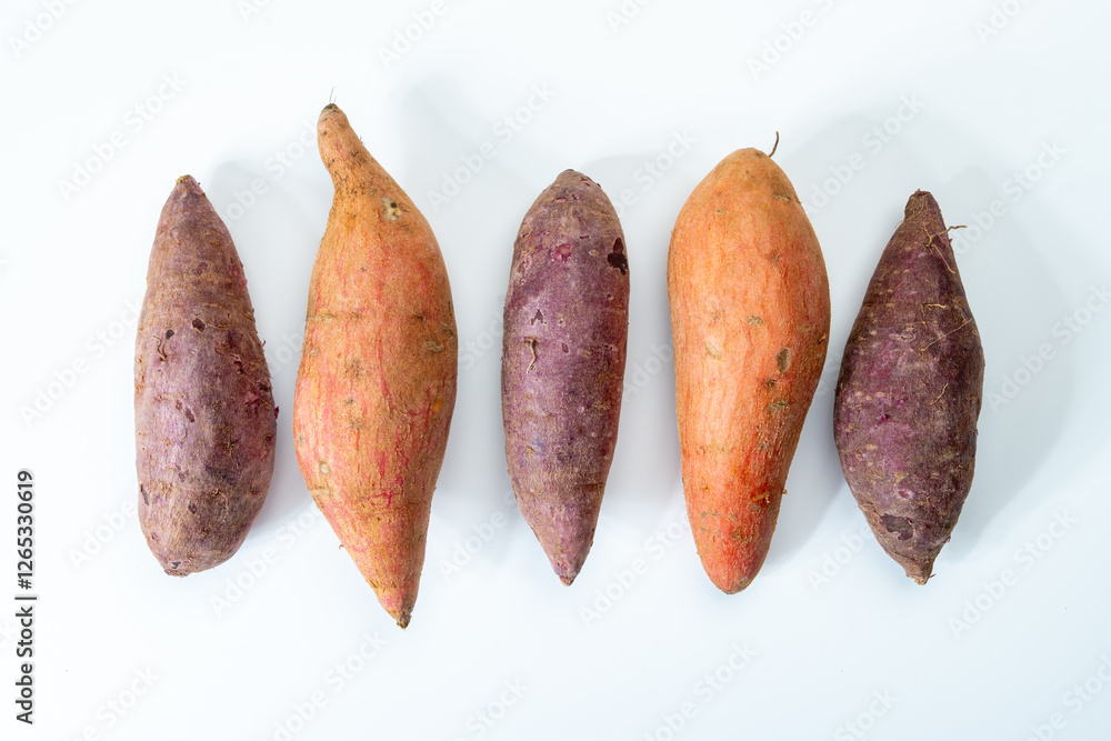 Colorful sweet-tasting tuberous roots vegetables purple and orange organic sweet potatos close up Colorful sweet-tasting tuberous roots vegetables purple and orange organic sweet potatos close up