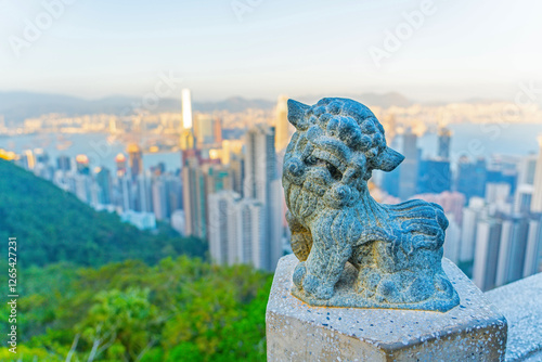 Photography Chinese lion sculpture on top of Victoria Peak with Hong Kong city in the backgr