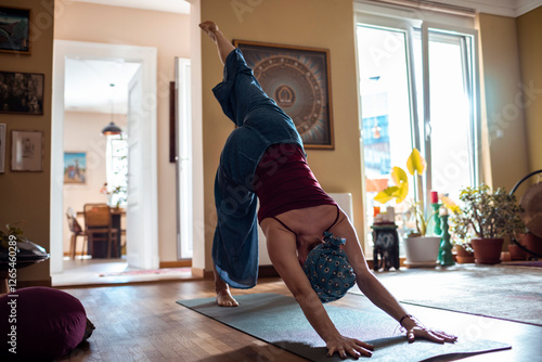 Woman meditating indoors with headscarf practicing yoga at home
