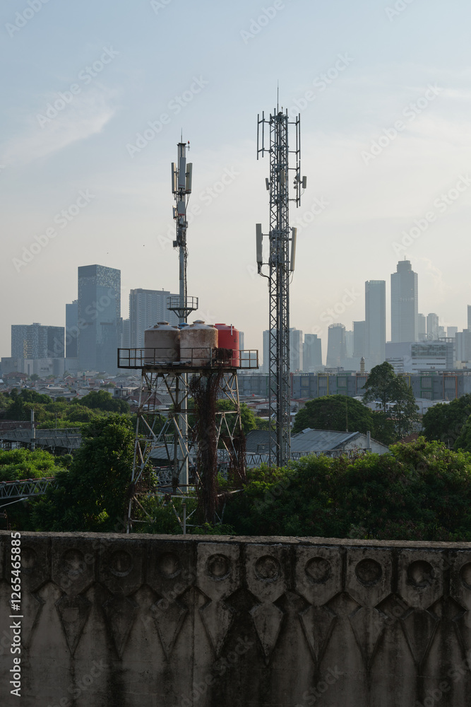 Obraz premium Cellular Towers and Water Tanks Overlooking the City