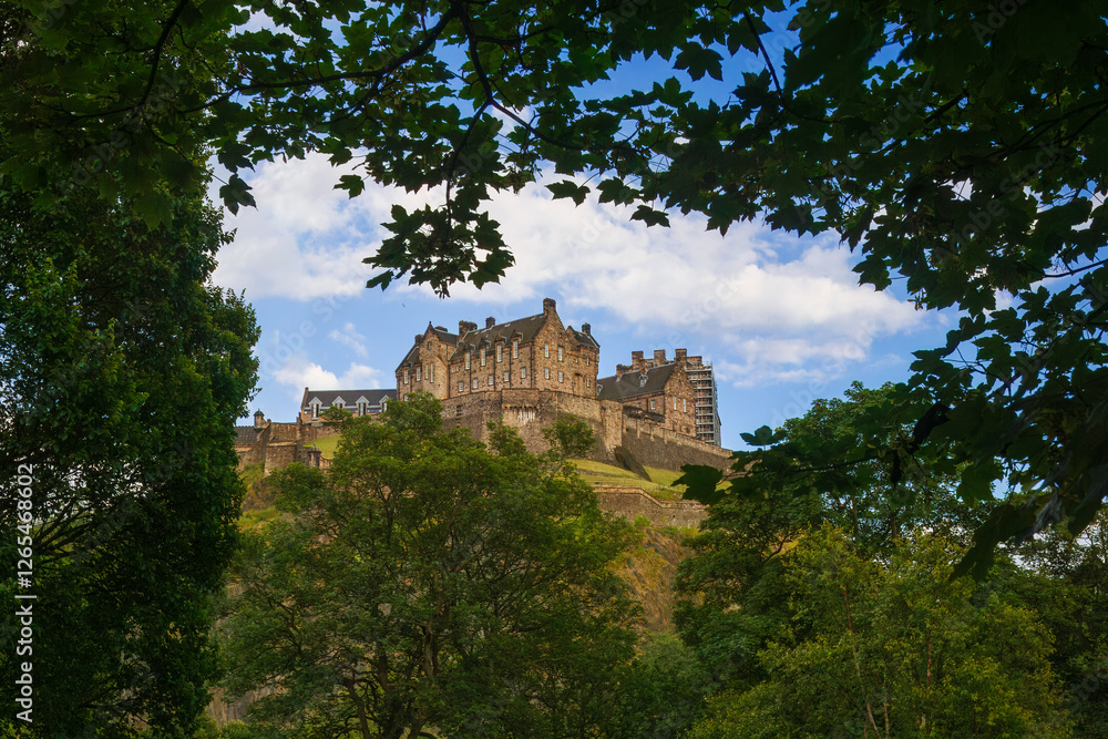 Scenic view of Edinburgh Castle over blue sky, Scotland. Edinburgh Castle is one of the most popular tourist attractions in Edinburgh city. Scenic view of Edinburgh Castle over blue sky, Scotland. Edinburgh Castle is one of the most popular tourist attractions in Edinburgh city.