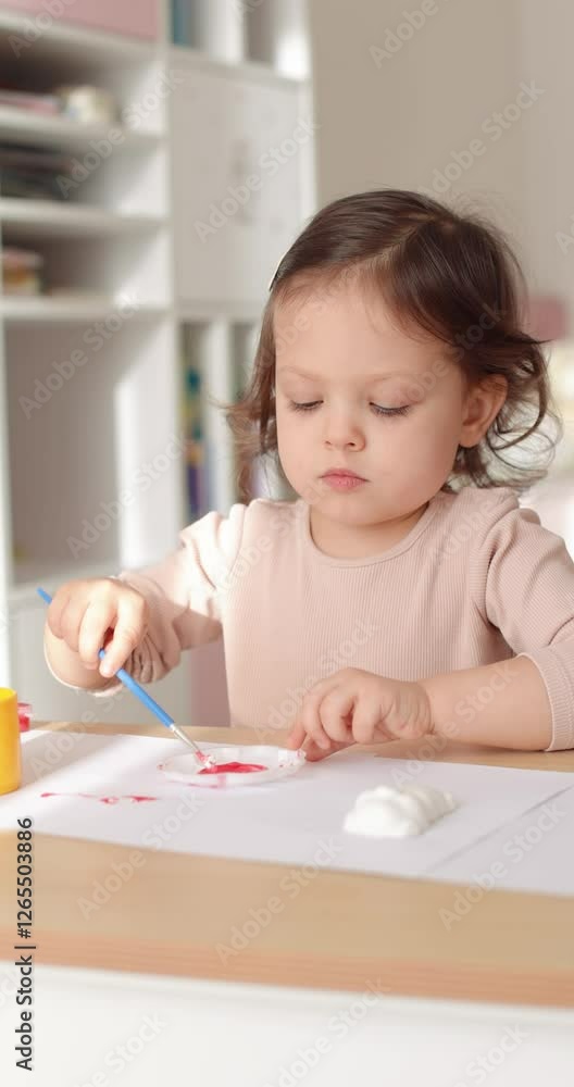 Cute child girl with mother painting at home, education concept. Cute child girl with mother painting at home, education concept.