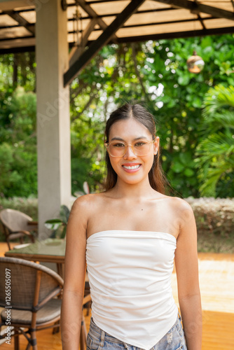 Woman smiling and looking at camera in garden cafe Free Download Woman smiling and looking at camera in garden cafe - GFXLoad