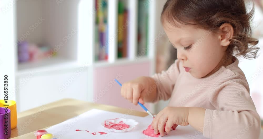 cute little child girl painting pig-shaped gypsum figure in pink. creativity. Handmade toy cute little child girl painting pig-shaped gypsum figure in pink. creativity. Handmade toy