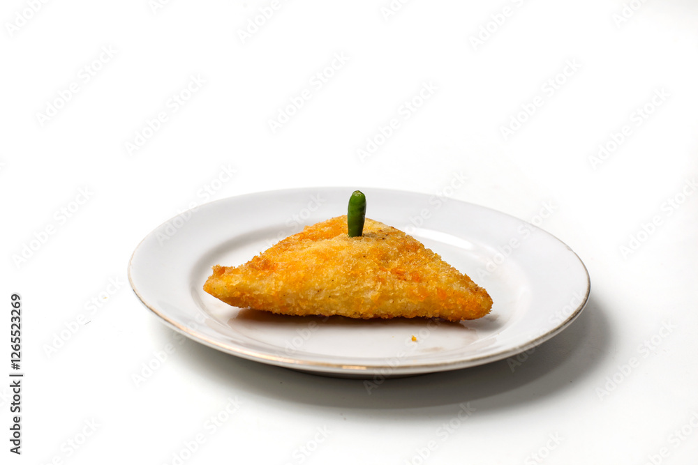 Mayo rissoles are triangular in shape, on a white plate, with chili on top Mayo rissoles are triangular in shape, on a white plate, with chili on top