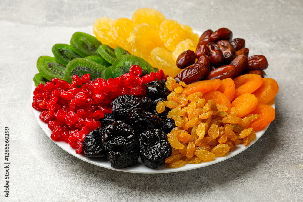 Mix of different dried fruits on gray textured table, closeup Mix of different dried fruits on gray textured table, closeup