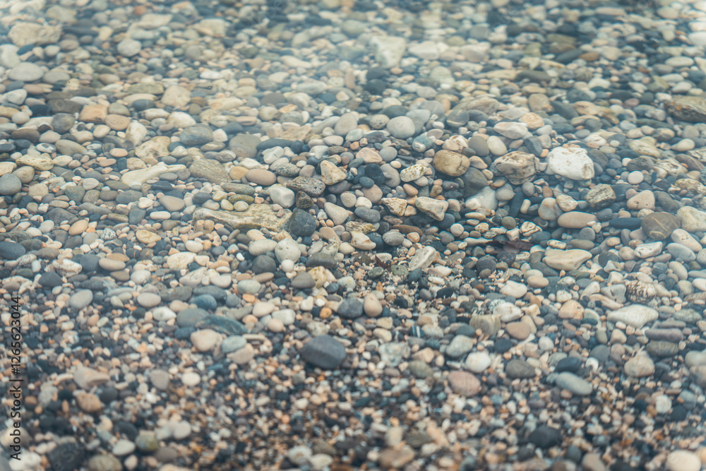 close-up of small pebbles at the beach, round pebbles, in the water of the lake in Savoie close-up of small pebbles at the beach, round pebbles, in the water of the lake in Savoie