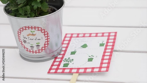 A close-up of a small metal plant pot with a 