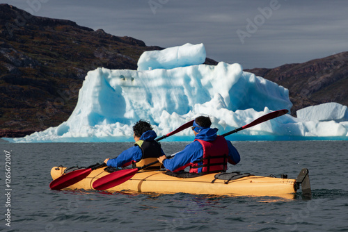 Kayaking in Tasiusaq ice fjord (South Greenland) photo