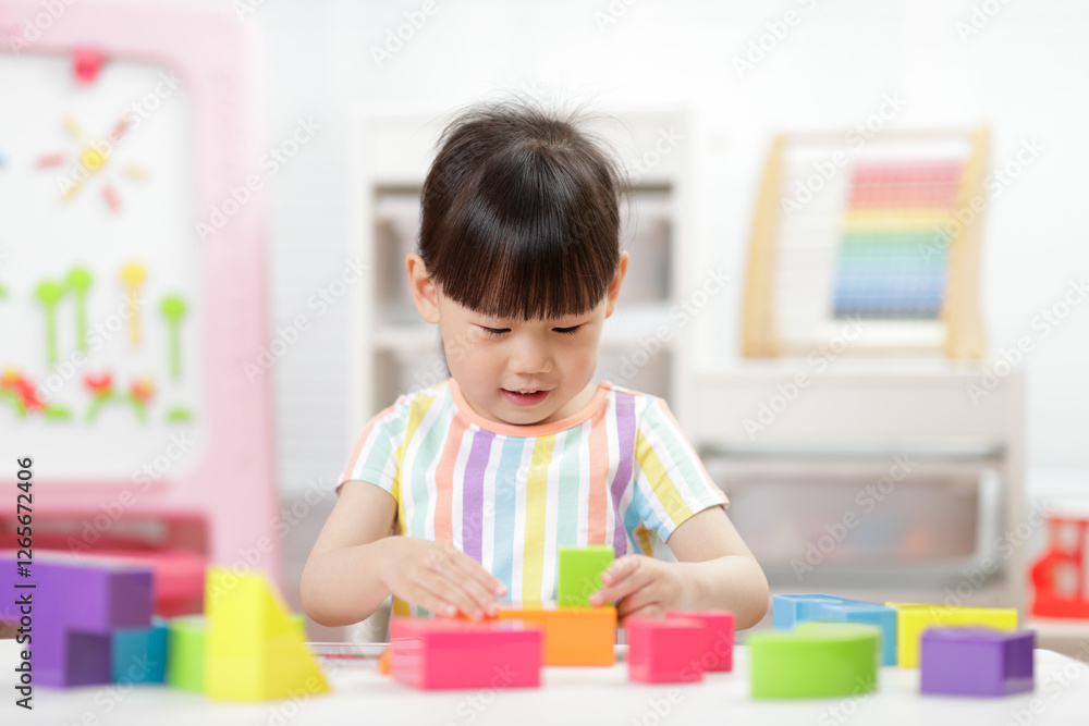A young girl engages in creative construction toys at home A young girl engages in creative construction toys at home