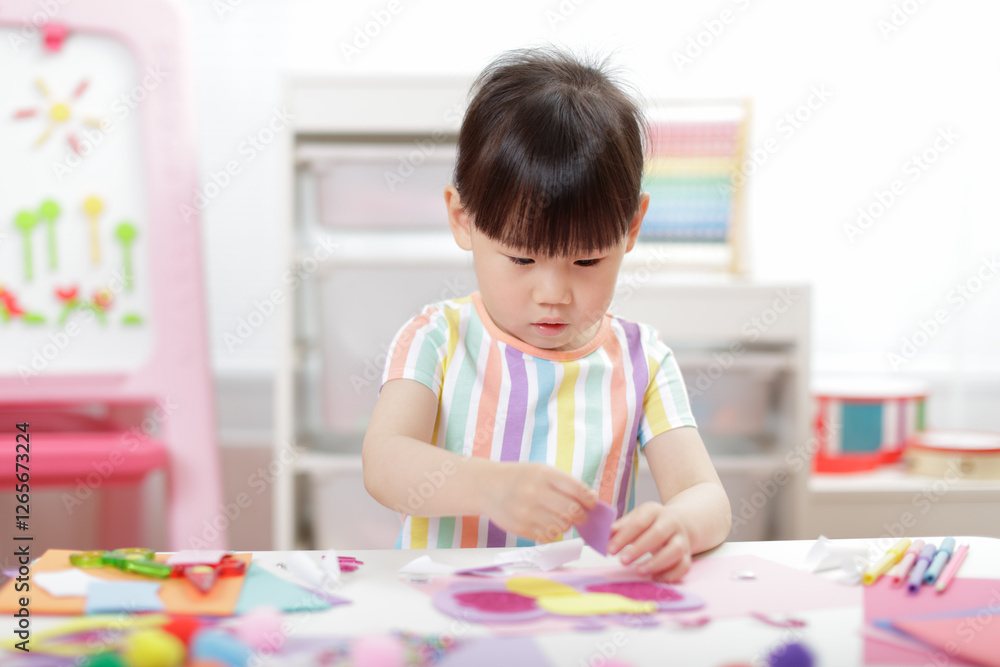A young girl was creating a craft at home A young girl was creating a craft at home