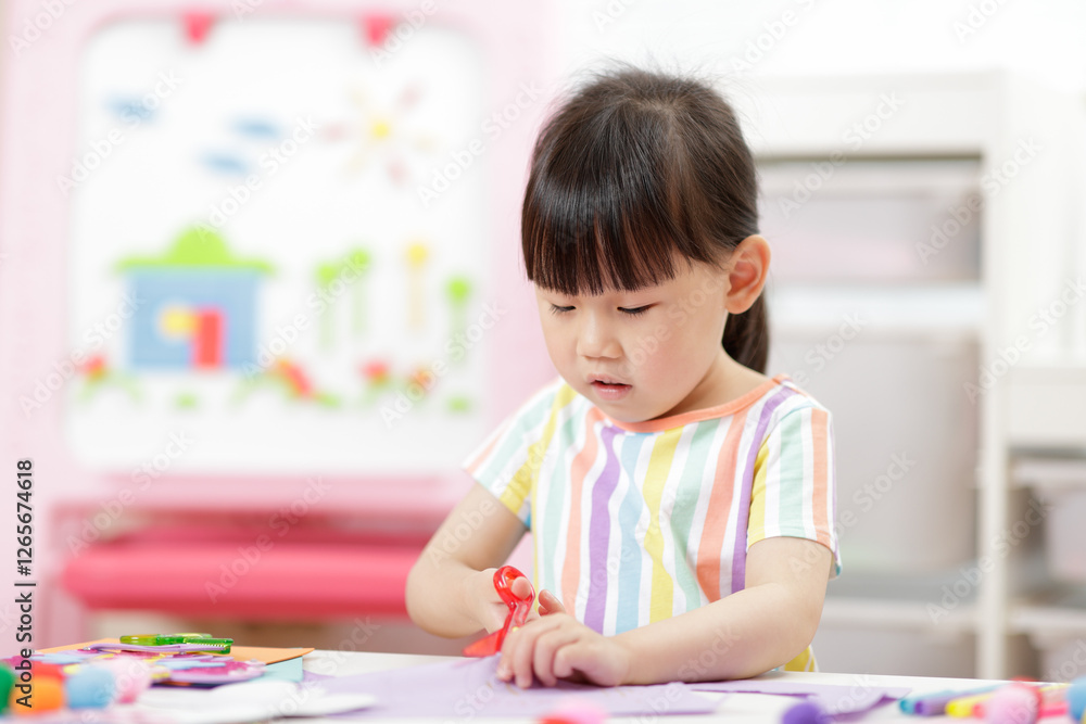 A young girl was creating a craft at home