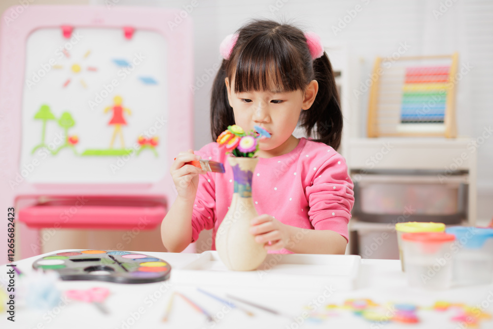 A young girl was making crafts at home. A young girl was making crafts at home.