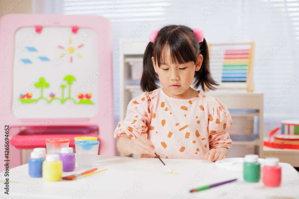 A young girl was making crafts at home.
A young girl was making crafts at home.