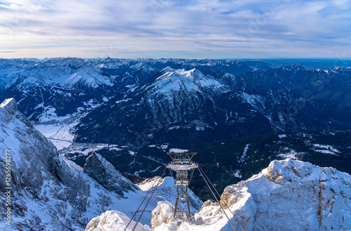 Stunning aerial panorama view of snow covered peaks of Allgaeu Alps in Bavaia from top of Zugspitze with blue sky and cloud in winter, Garmisch-Partenkirchen, Bavaria, Germany photo