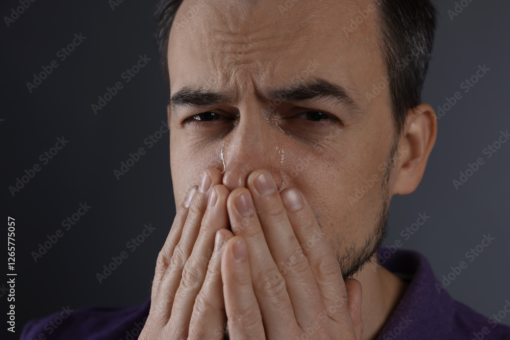 Sad man crying on grey background, closeup Sad man crying on grey background, closeup