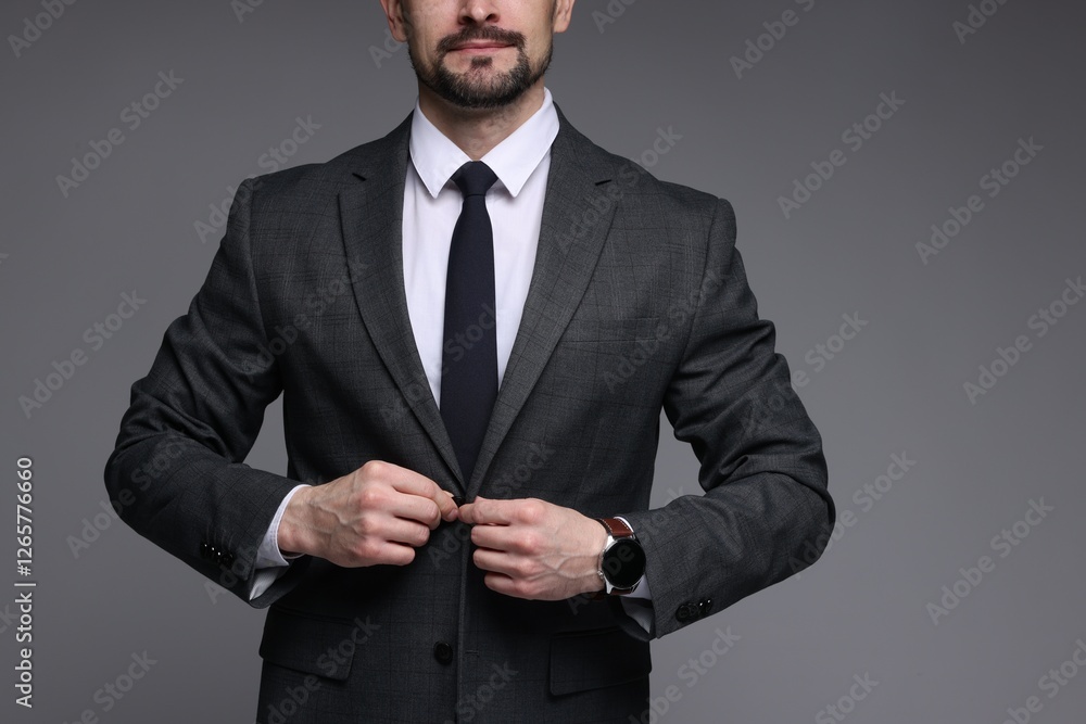 Man in classic suit on grey background, closeup Man in classic suit on grey background, closeup