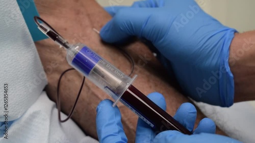 Medical Doctor Drawing Blood Sample with Syringe White Labcoat Blue Gloves Close Up