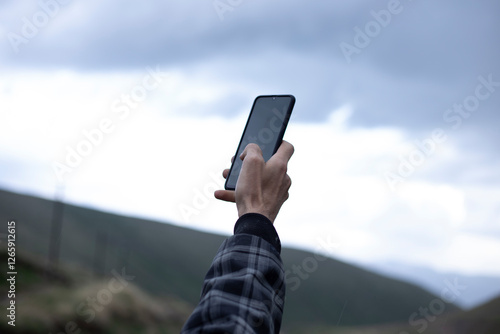 hand with a phone searching for signal
