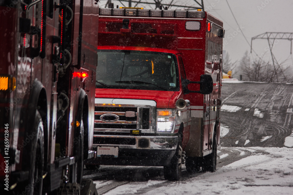 Fire engine and ambulance responding to emergency in falling snow Fire engine and ambulance responding to emergency in falling snow