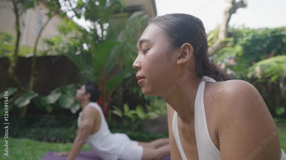 Three Person Yoga Pose Movement On Beautiful Lush Garden Green Grass in Ubud Bali Indonesia Three Person Yoga Pose Movement On Beautiful Lush Garden Green Grass in Ubud Bali Indonesia