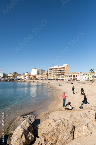 group of people enjoying the nice sunny weather at the beach in february, Portixol, Mallorca
