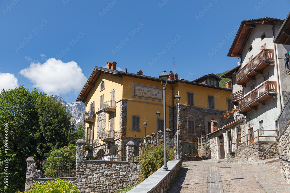 GROMO, ITALY - MAY 22, 2024: Street view of historical village with narrow cobbled streets, shot in bright summer light