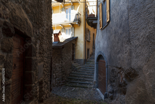 Obraz na płótnie Street view of historical village Gromo, Bergamo, Lombardy, Italy. Narrow cobbled streets. Sun lights and shadows. w salonie