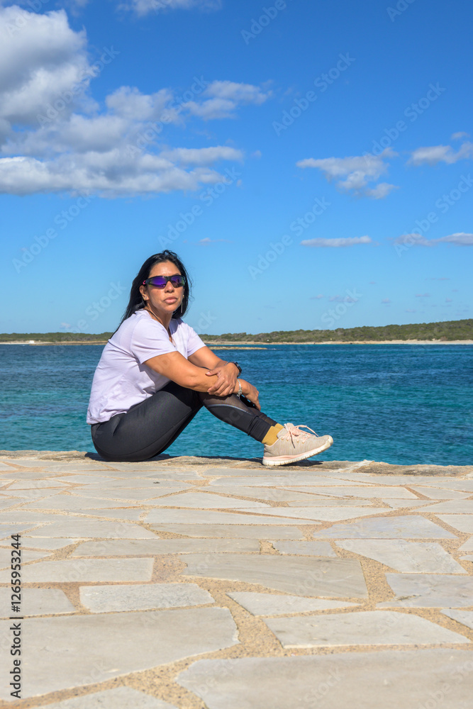 Latin woman with sunglasses enjoying the sea in Mallorca. Latin woman with sunglasses enjoying the sea in Mallorca.