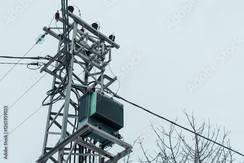 Obraz na płótnie Smal transformer station on the top of power line pole. Frog view of a voltage transformer in a small village w salonie