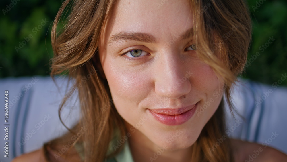 Obraz premium Closeup cheerful woman smiling gently surrounded by green ivy leaves. Happy lady